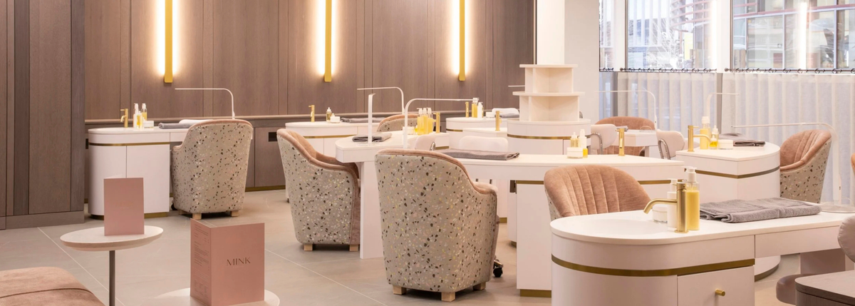 Salon interior with multiple treatment stations and chairs.